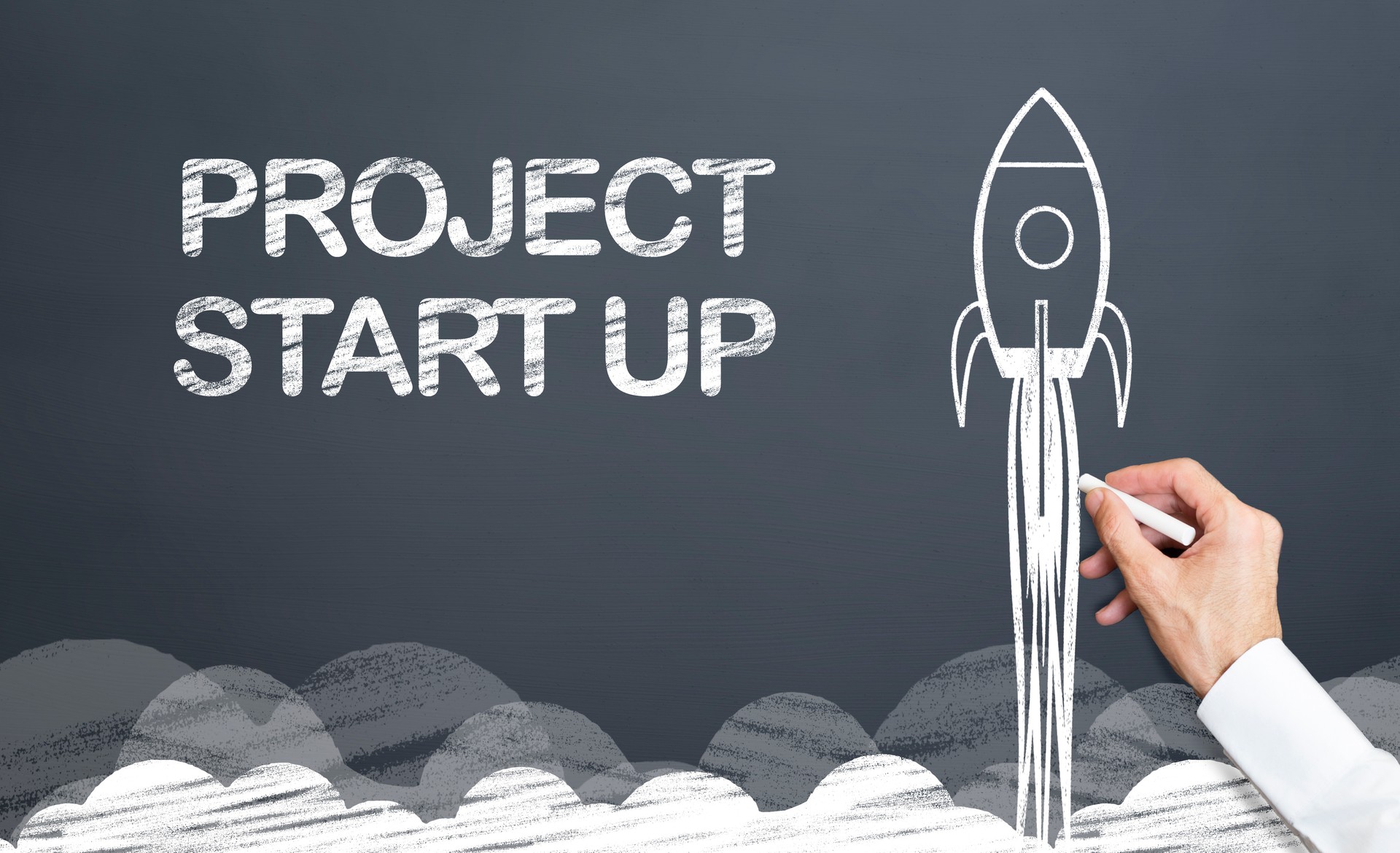 start up project concept with rocket on blackboard